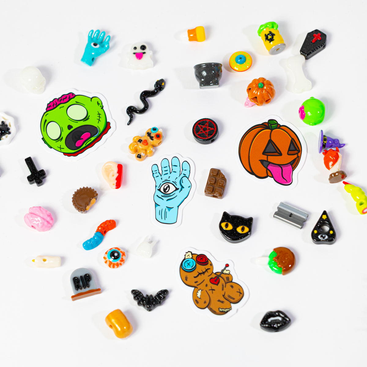 Halloween kandi beads scattered on white with four die-cut limited edition sticker designs