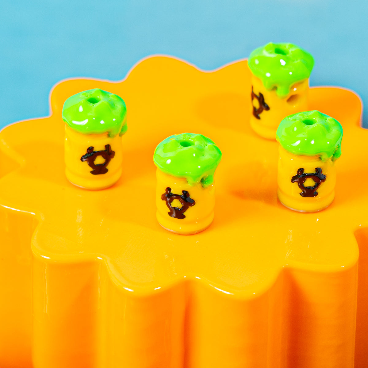 Biohazard barrel kandi beads with black symbols spread across an orange riser