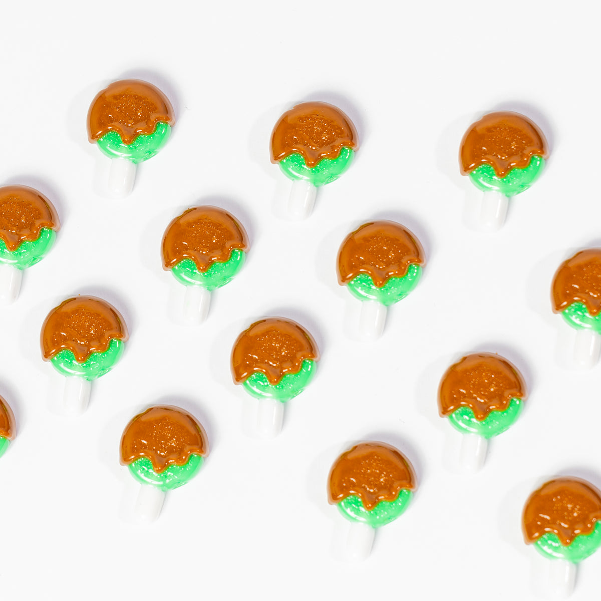 Caramel dipped apple kandi beads scattered on white