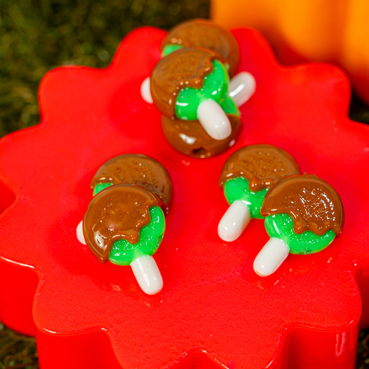 Caramel apple kandi beads spread across a red riser