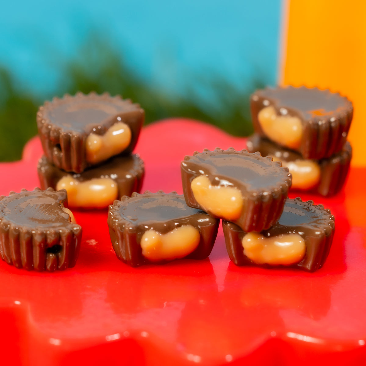 Close-up of stacked chocolate peanut butter cup kandi beads on a red riser