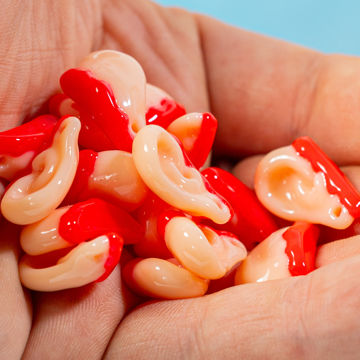A handful of cream and red severed ear kandi beads