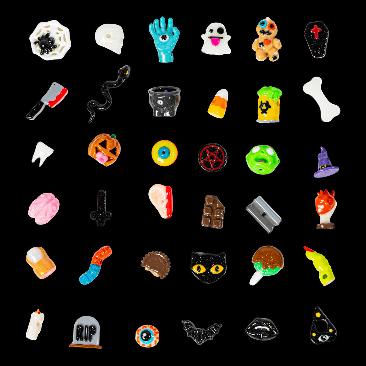 Grid of Halloween kandi beads on black: skulls, bats, candy corn, eyeballs, ghosts, coffins and more