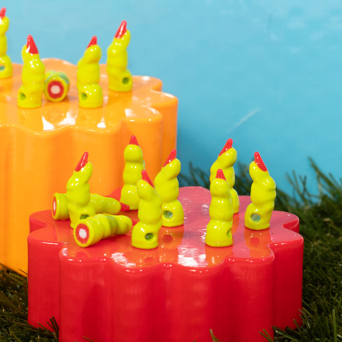 Lime green witch finger kandi beads with red nails standing on orange and red risers